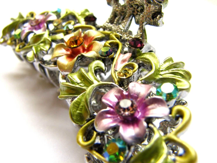 this brooch is adorned with crystal flowers and leaves