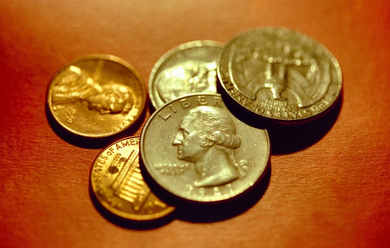 an orange surface with several coins in it