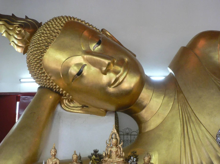 an elaborate gold buddha statue with intricate details