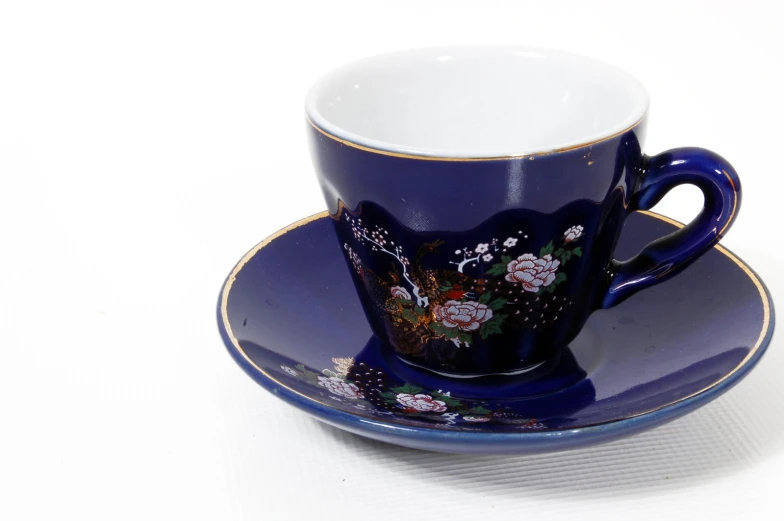 a cup and saucer are sitting on a table