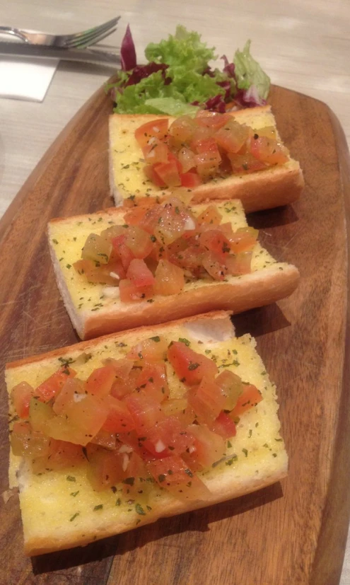 some bread with some tomatoes on them are on the table