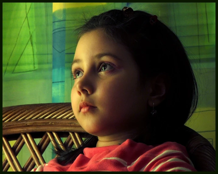 a close - up image of a girl looking off into the distance