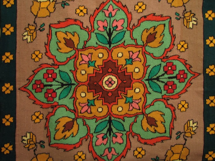 a green rug with a red flower on it