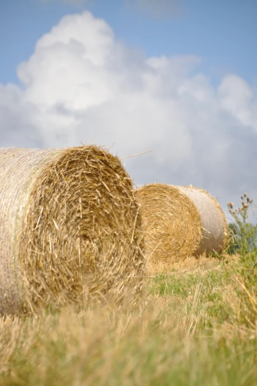 hay bales sitting in a field on a clear day