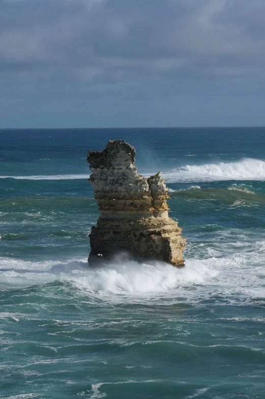 the rocks are in rough water near the shore