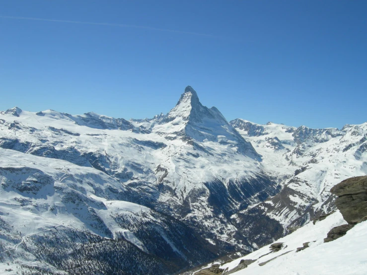 there is a very large mountain with many snow on it