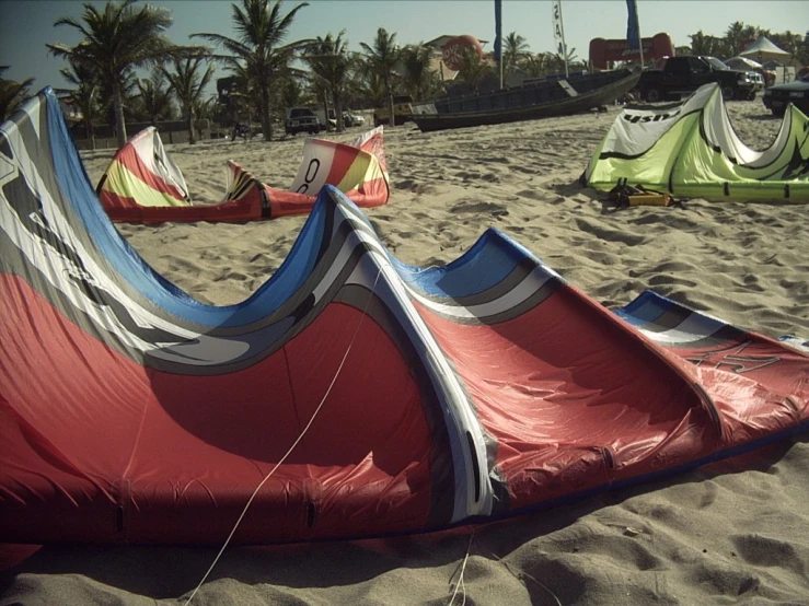 a bunch of tents are laying on a beach