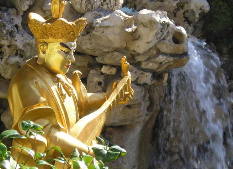 a buddha statue holding soing in each hand