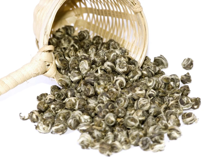 a white background has a basket full of gray seed