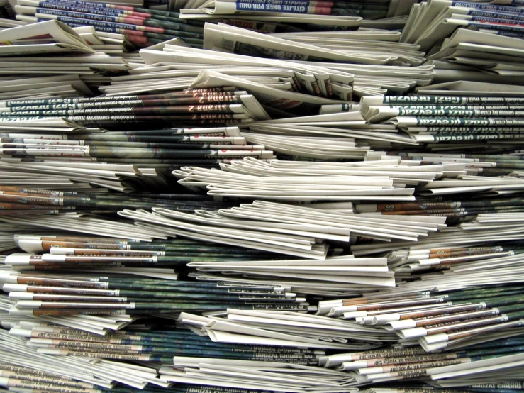 several stacks of newspapers stacked on top of each other