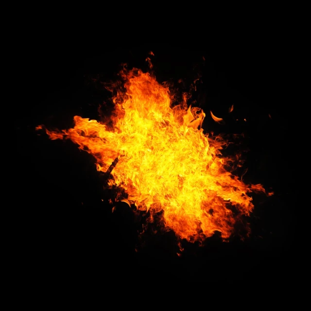 a black background is blurry to the left with a bright yellow orange fireball that appears to be in flames