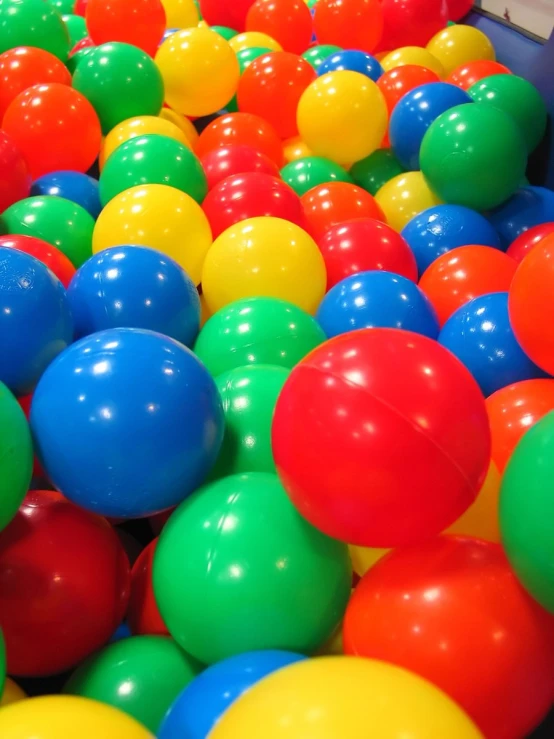 many different colored balls of various sizes and shapes