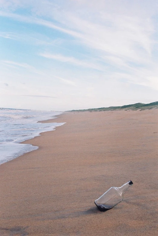 a message in a bottle left on the sand