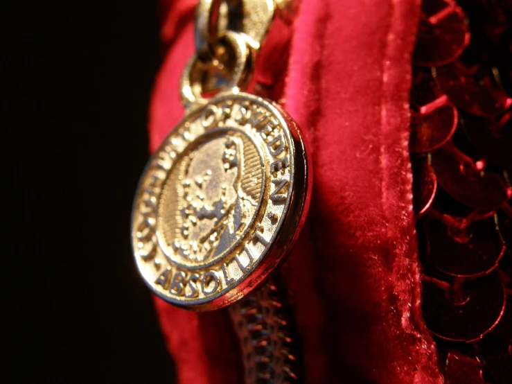 the back side of a necklace with the emblem on it