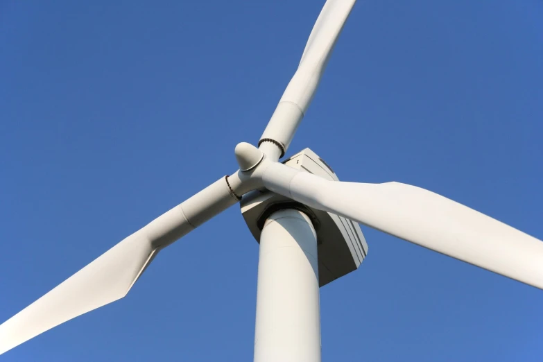 a wind turbine with a blue sky in the background