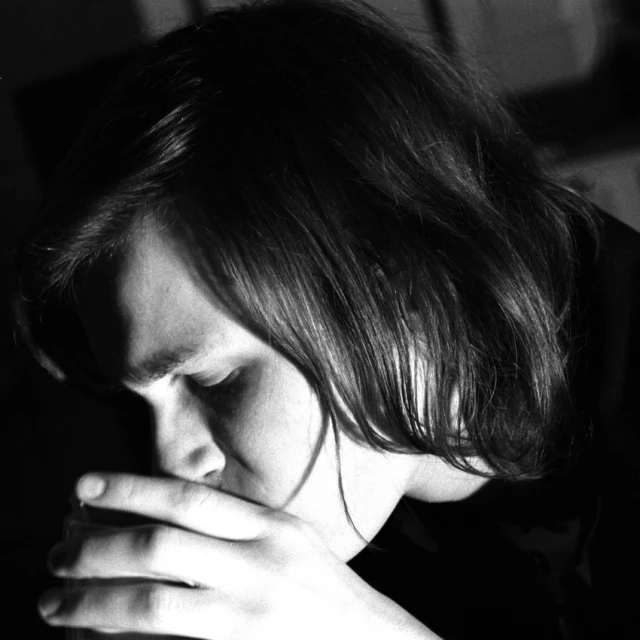 a person with their hands together praying