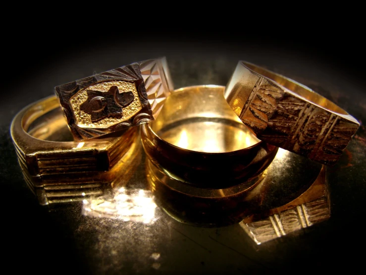 several gold rings with intricate design on them