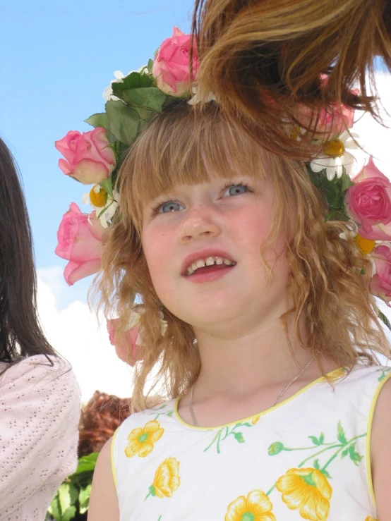 a little girl who has a flower on her head