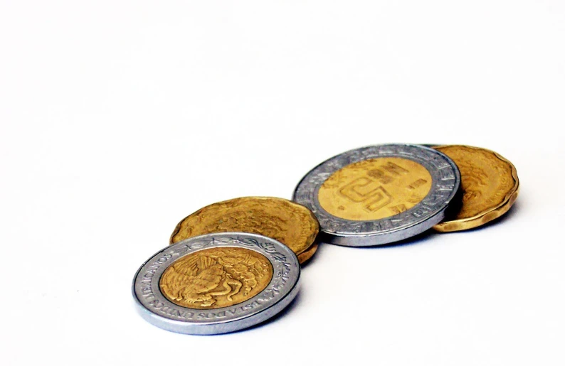 a set of three gold and silver indian one rupee coin