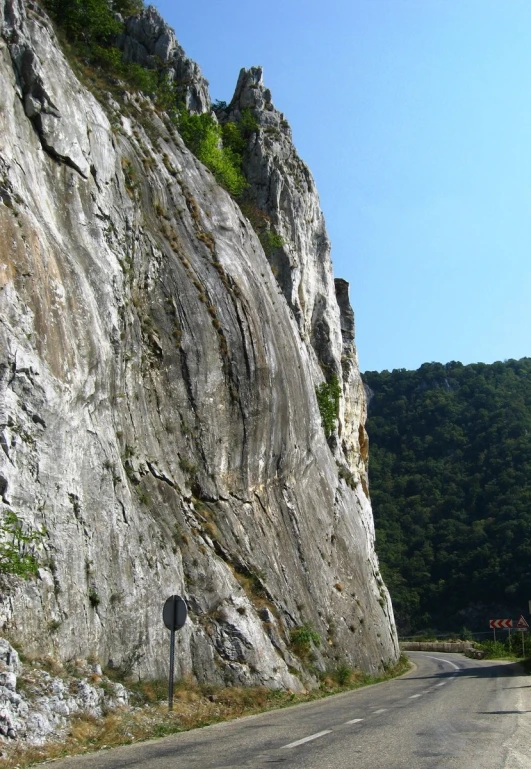 the view of a road from between two mountains