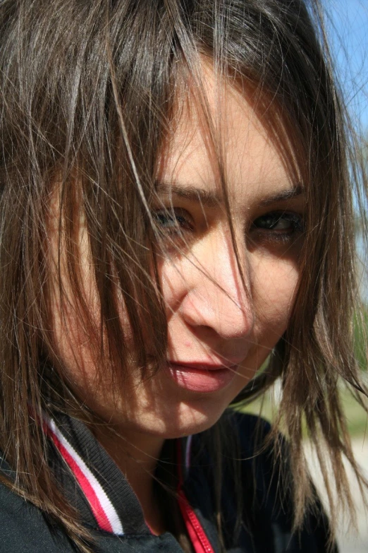 a girl with brown hair is holding a phone