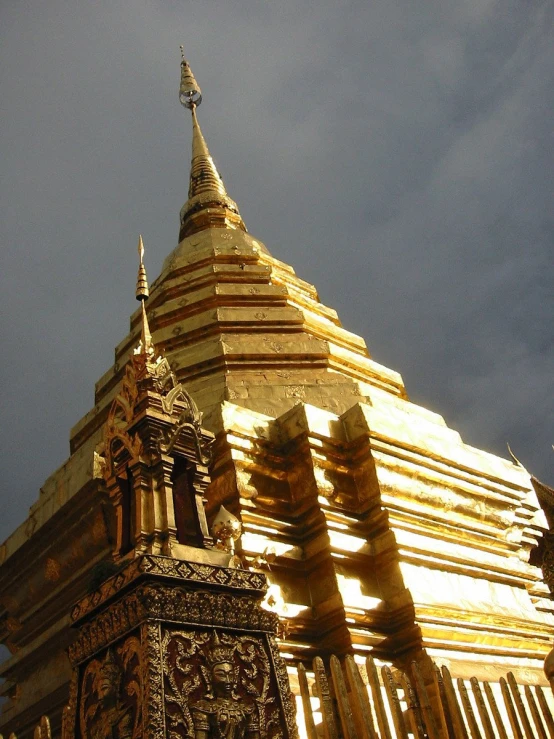 a gold painted building with a clock at the top