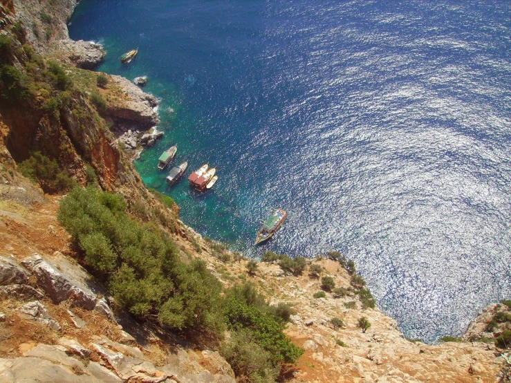 an aerial view of several small boats in a bay