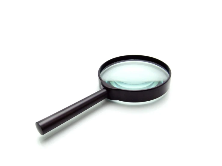 a magnifying glass sitting on top of a white table