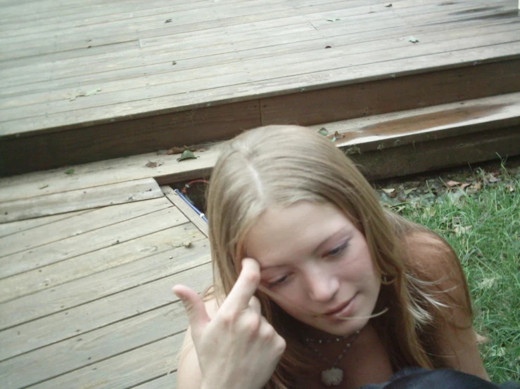 a girl on her knees showing off her peace sign