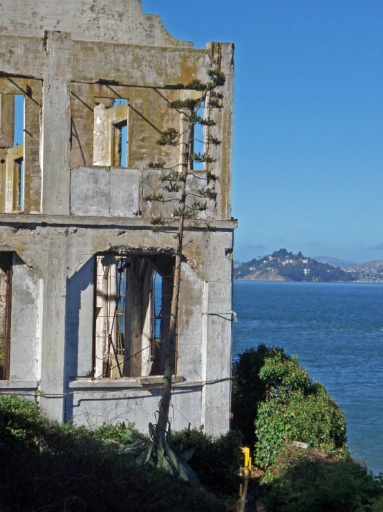 an old building in front of the ocean