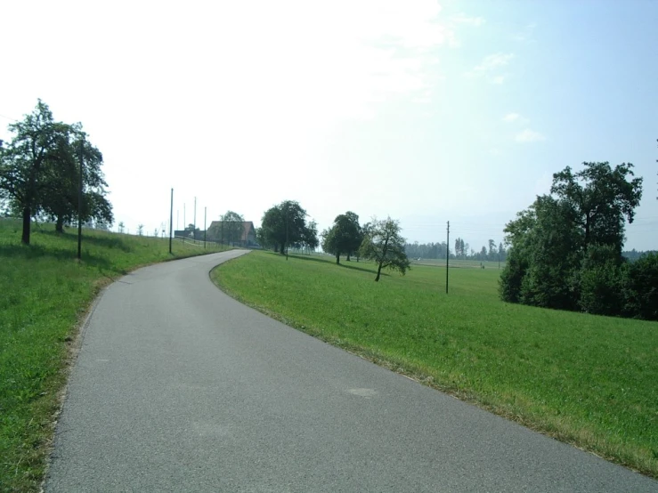 a long paved roadway on a country road