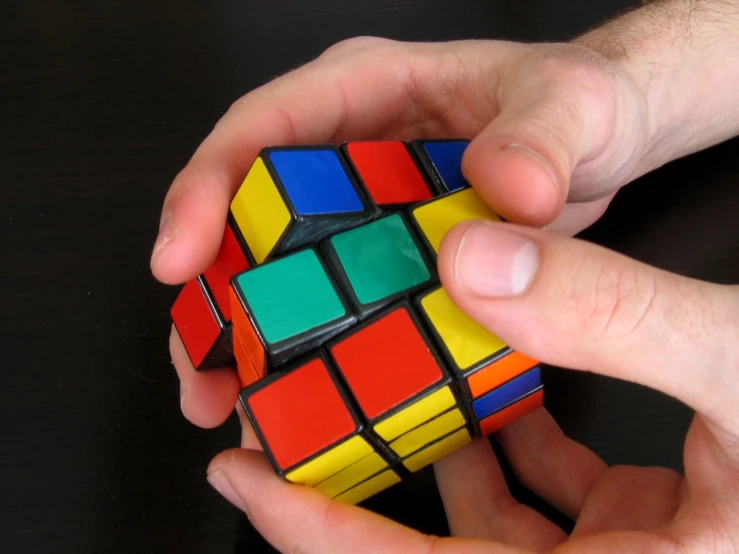 a man and woman playing with a rubik cube