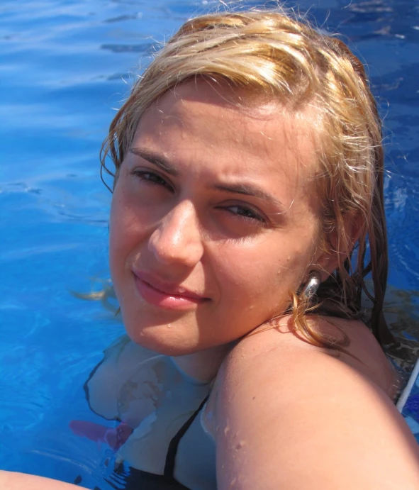 a girl posing for a po in the pool