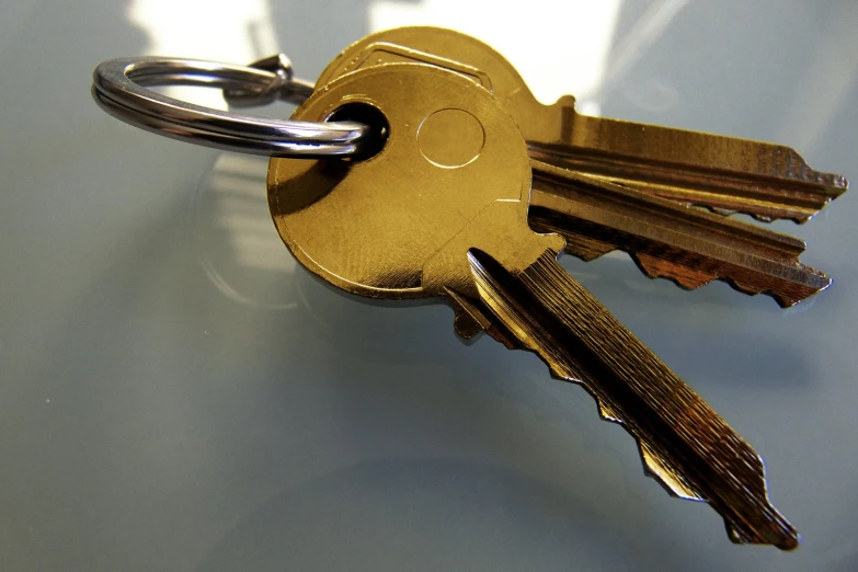 four golden keys are sitting on a surface