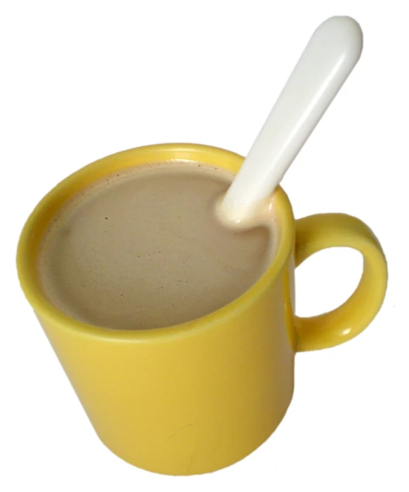 the mug with the spoon in it is filled with liquid
