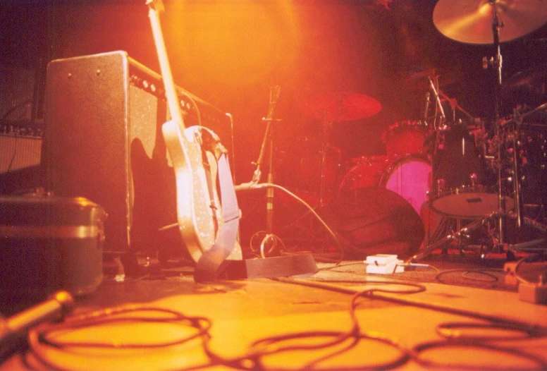 two electric guitars and amp on a stage