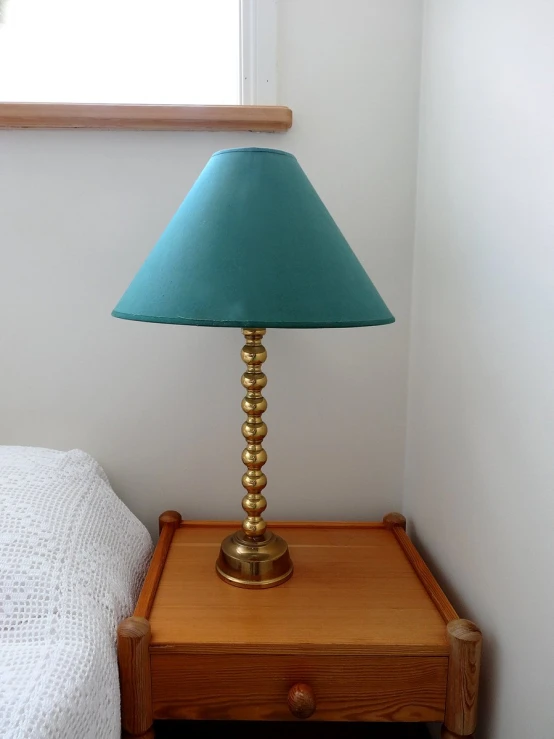 there is a small lamp next to a small bed