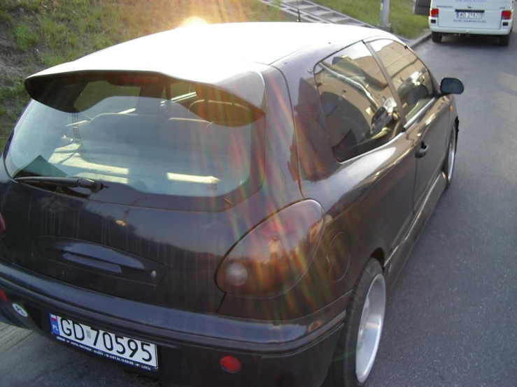 the back end of a car that is sitting on the road