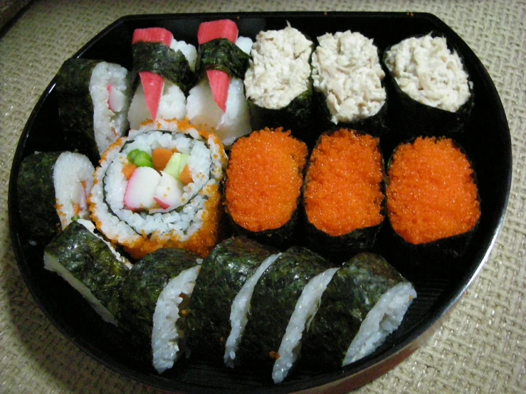 sushi is being displayed on the plate with carrots