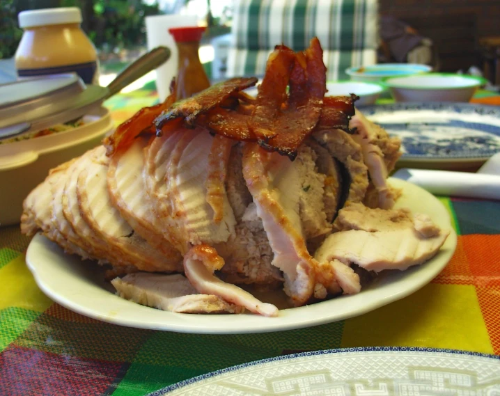 a plate full of sliced pork is shown