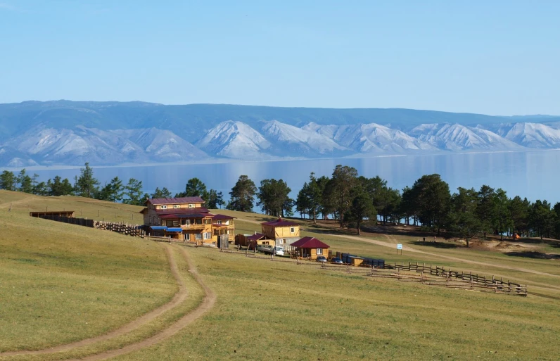 several buildings sitting along the side of a large hill