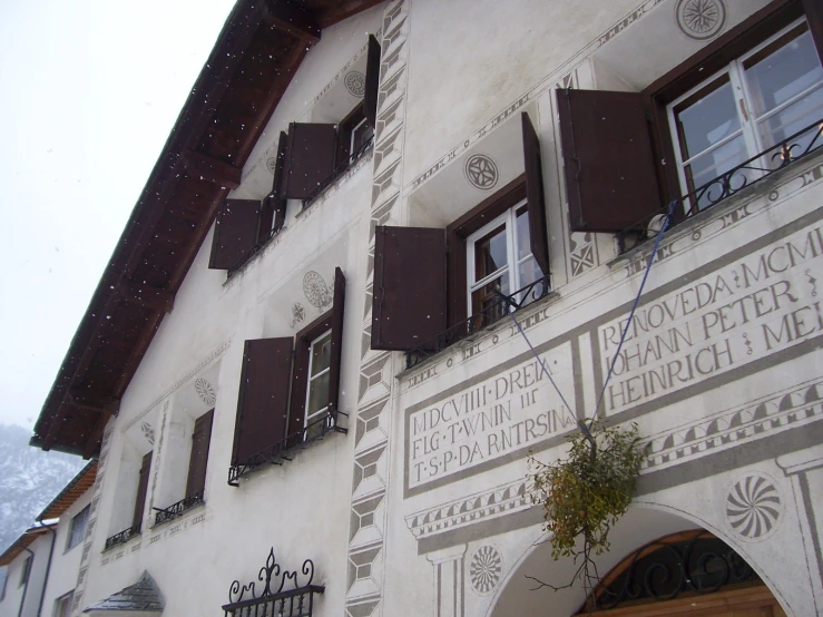 some brown and white window shutters and a building