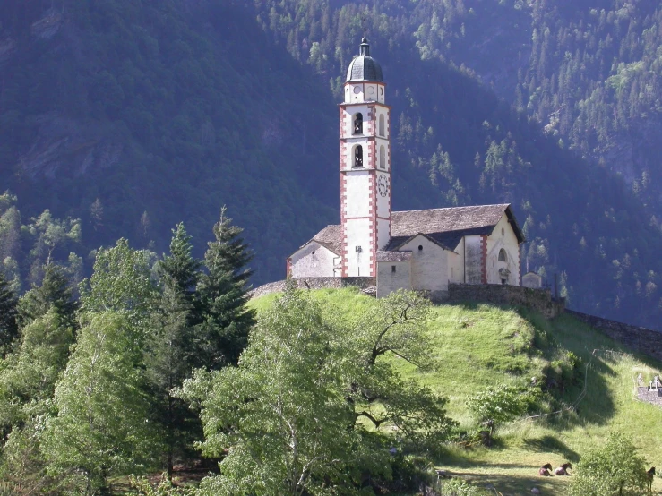 an old church on a hill with a tower