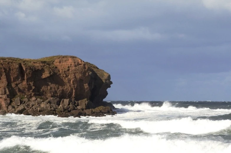 a person standing on the edge of an ocean cliff