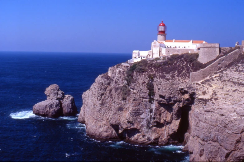 a tall tower that is perched on the top of a cliff