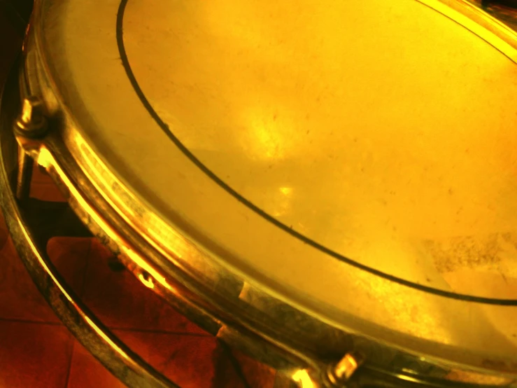 a silver metal pan on red tile with wooden floor