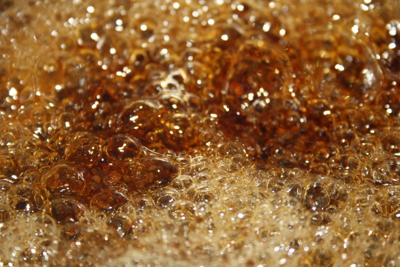 brown liquid is bubbles on a yellow surface