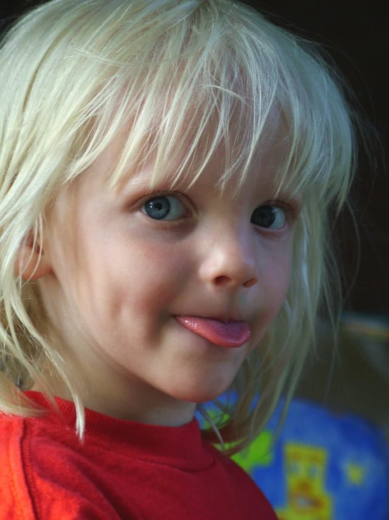 the young child has a toothbrush in her mouth