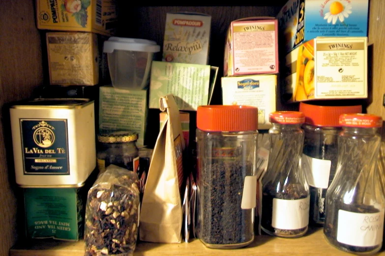 a variety of spices and coffee is displayed on a shelf