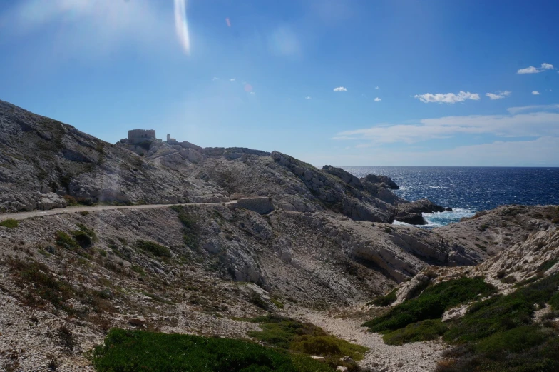 a path winding a coastal trail, leading towards the water